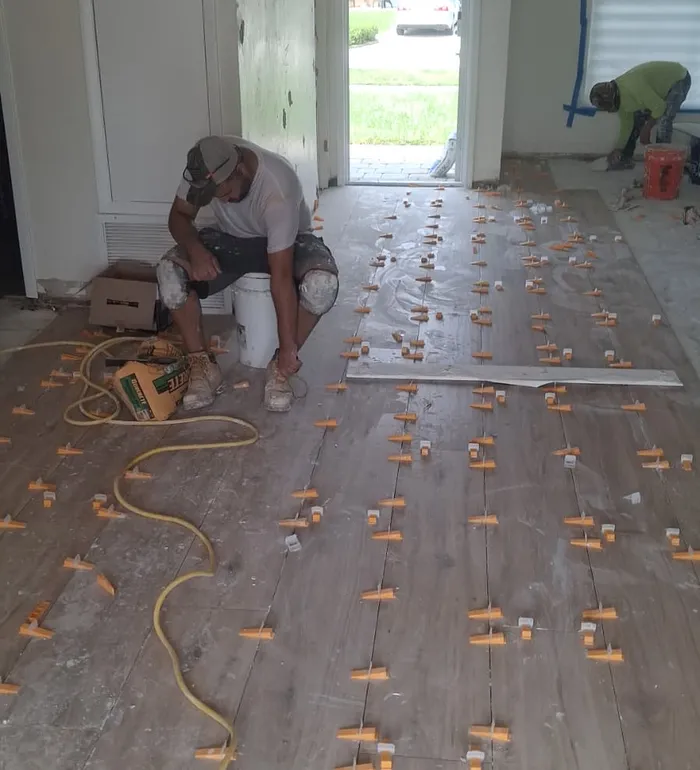 Flooring installation in progress with spacers — Butler project